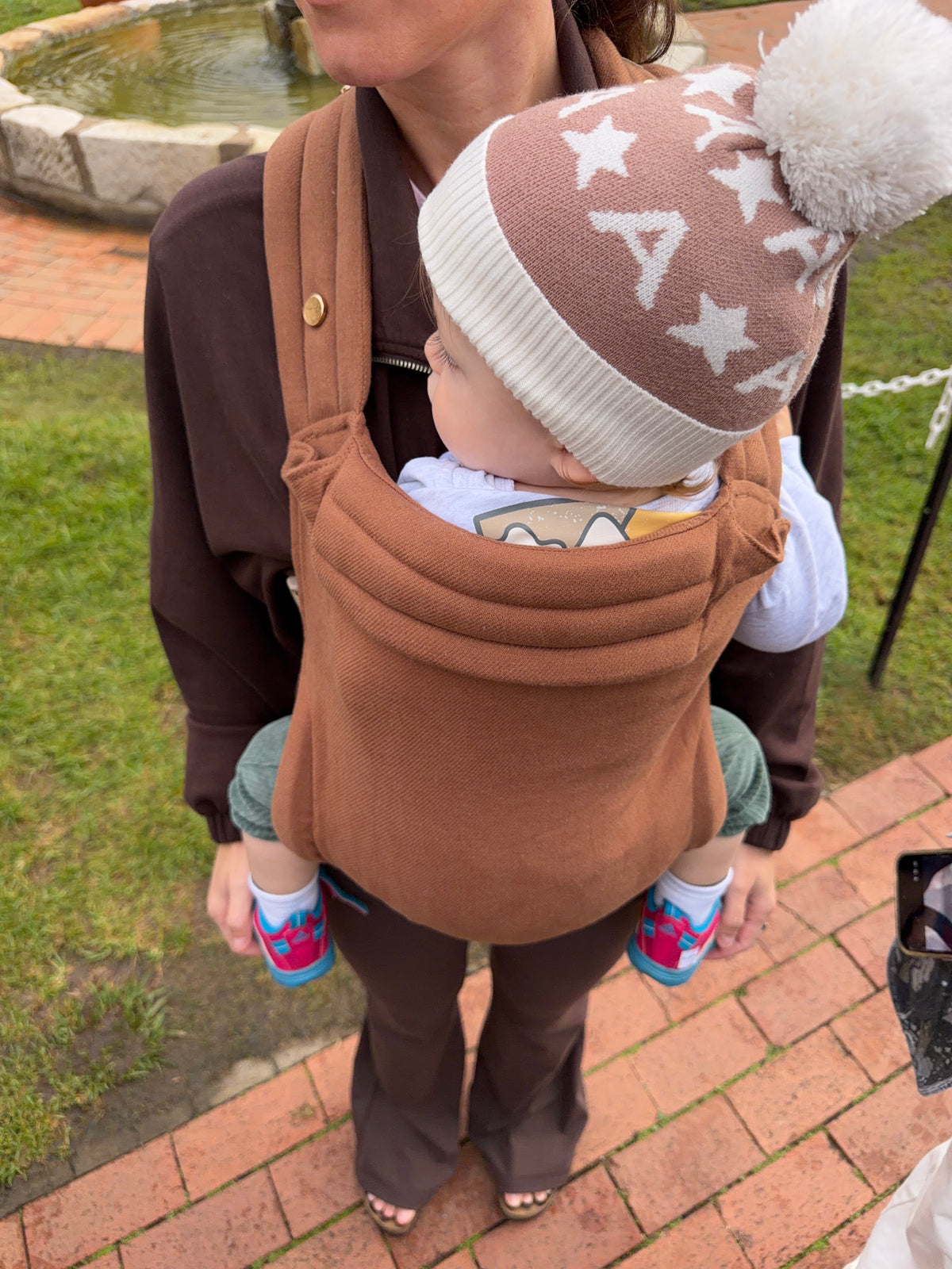 Clay | Mum carrying baby in August baby carrier close up of front