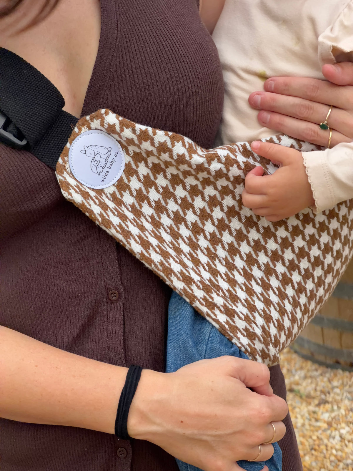 Dune | mum carrying toddler in ever toddler carrier closeup of logo